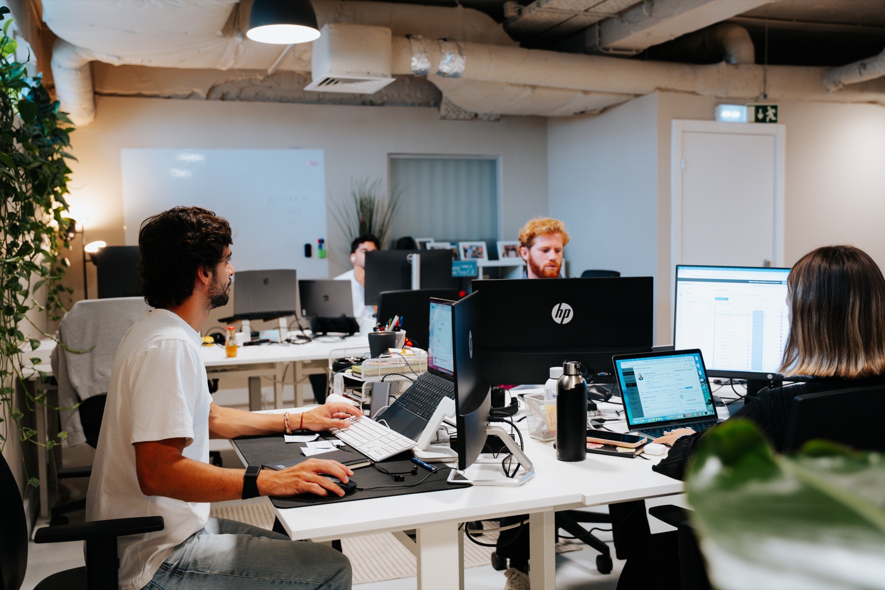 The Atlana office in Lisbon: engineers at their desks across an open-plan workspace
